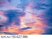 Captivating sunset sky filled with vibrant hues of orange, pink, and purple, creating a dramatic and serene atmosphere. Wispy clouds enhance the beauty of the evening sky. Стоковое фото, фотограф Ольга Ильина / Фотобанк Лори