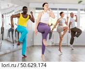 Asian girl with team of like-minded multinational people learn to elements of hip hop dance. Стоковое фото, фотограф Яков Филимонов / Фотобанк Лори