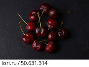 Rotten ripe cherries with mold and rotten sides on a black background. Seasonal fruits, harvest. Selective focus, close-up. Стоковое фото, фотограф Наталья Любина / Фотобанк Лори