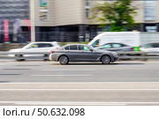 Side view of BMW 5 series in motion. Gray car moving fast on the street. Редакционное фото, фотограф Константин Григорьев / Фотобанк Лори