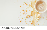 Coffee cup spills on a white surface, creating a messy splash in the morning light. Стоковое AI-изображение, AI-художник Сергей Толмачёв / Фотобанк Лори