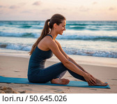 A woman is sitting on a mat on the beach, looking at the ocean. Стоковое AI-изображение, AI-художник Ярославский Максим / Фотобанк Лори