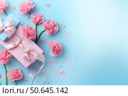 Pink carnations and gift boxes on sky blue background with heart confetti. Стоковое AI-изображение, AI-художник Иван Рябоконь / Фотобанк Лори