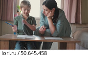 Mom education son writing. Kids learn and study in home school. Mommy female helping teaching little boy support studying, learning homework. Child care teach study. Knowledge day. Children schooling. Стоковое видео, видеограф Марина Демидюк / Фотобанк Лори