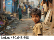 Poor indian child standing in slum, facing poverty and hardship. Стоковое AI-изображение, AI-художник Иван Рябоконь / Фотобанк Лори