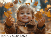 Little boy having fun during stroll in the forest at sunny autumn day. Child playing maple leaves. Baby tossing the leaves up. Active family time on nature. Hiking with little kids. Dry leaves rustle. Стоковое AI-изображение, AI-художник Ирина Михайличенко / Фотобанк Лори