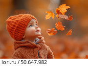 Little boy having fun during stroll in the forest at sunny autumn day. Child playing maple leaves. Baby tossing the leaves up. Active family time on nature. Hiking with little kids. Dry leaves rustle. Стоковое AI-изображение, AI-художник Ирина Михайличенко / Фотобанк Лори