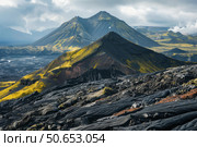 Volcanic landscape with yellow moss covering black solidified lava. Стоковое AI-изображение, AI-художник Иван Рябоконь / Фотобанк Лори