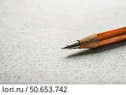 Close up of a wooden pencil lying on a handwritten text document. Стоковое AI-изображение, AI-художник Иван Рябоконь / Фотобанк Лори