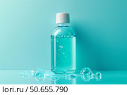 Micellar water bottle with bubbles on reflective surface and turquoise background. Стоковое AI-изображение, AI-художник Иван Рябоконь / Фотобанк Лори
