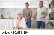 Adult woman sits at table and thinks how to resolve conflict with her husband and son. Стоковое видео, видеограф Яков Филимонов / Фотобанк Лори