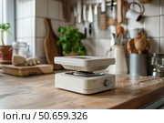 Portable induction cooker preparing food in a modern kitchen. Стоковое AI-изображение, AI-художник Иван Рябоконь / Фотобанк Лори