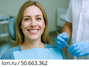 Smiling blonde woman sitting in dental chair confident healthy white teeth friendly clinic checkup concept for preventive oral care advertising. Стоковое AI-изображение, AI-художник Павел Муравьев / Фотобанк Лори