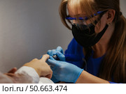 Getting Manicured Nails at a Beauty Shop During Covid in Reno. Стоковое фото, фотограф Aleksandr Golubev / Фотобанк Лори