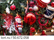 The Nutcracker on the New Year's tree in Moscow. New Year's card 2026. Beautiful Christmas background. Concept of preparing decorations and attire for the New Year. Стоковое фото, фотограф Photojuli / Фотобанк Лори