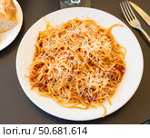Plate of Italian spaghetti topped with ground beef Bolognese sauce. Стоковое фото, фотограф Яков Филимонов / Фотобанк Лори
