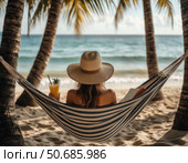 A woman is relaxing on a beach with a book and a drink. Стоковое AI-изображение, AI-художник Ярославский Максим / Фотобанк Лори
