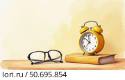 Yellow alarm clock and glasses resting on a book with a soft background and copy space. Стоковое AI-изображение, AI-художник Елена Скрипкина / Фотобанк Лори