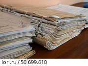 Стопки подшитых архивных книг, лежащие на столе. Стоковое фото, фотограф Snezka / Фотобанк Лори