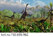 Velociraptor dinosaurs attack a Camarasaurus for their next meal. Стоковое фото, фотограф Mark Stevenson/Stocktrek Images / ТАСС / Фотобанк Лори