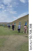 ELANTSY VILLAGE, IRKUTSK REGION, RUSSIA - July 05, 2025: Vertical video of traditional Buddhist serge pillars with colored ribbons near sacred Erd mountain. People sprinkle rice and tie hodak during Erdyn Games festival. Редакционное видео, видеограф Виктория Катьянова / Фотобанк Лори