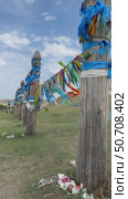 ELANTSY VILLAGE, IRKUTSK REGION, RUSSIA - July 05, 2025: Vertical video of traditional Buddhist pillars Serge with colored ribbons near sacred mountain Erd during Erdynskie Games festival. Closeup view. Редакционное видео, видеограф Виктория Катьянова / Фотобанк Лори