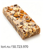 Delicious nougat bar covered with almonds and hazelnuts on white background. Стоковое AI-изображение, AI-художник Иван Рябоконь / Фотобанк Лори