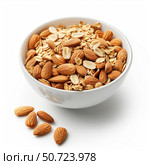 Bowl overflowing with tasty almonds and oat flakes creating healthy breakfast delight. Стоковое AI-изображение, AI-художник Иван Рябоконь / Фотобанк Лори