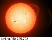 Illustration of the sun with visible dark sunspots on the surface, prominences and some solar wind. Стоковое фото, фотограф Fahad Sulehria/Stocktrek Images / ТАСС / Фотобанк Лори