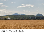 A heavy transport aircraft Antonov An-124 stands at the airport Mineralnye Vody against the backdrop of the mountains. Редакционное фото, фотограф Сергей Сергеев / Фотобанк Лори