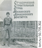 Юноша в униформе на фоне плаката: "Студенческий строительный отряд Московского авиационного института" Стоковое фото, фотограф Retro / Фотобанк Лори