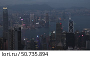 Wonderful aerial view of skyscrapers in downtown and Victoria Harbor in Hong Kong at night. Awesome cityscape. Hong Kong is a popular tourist destination of Asia. Редакционное видео, видеограф Ирина Михайличенко / Фотобанк Лори