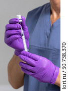 Doctor wearing purple nitrile gloves preparing vaccine with syringe. Стоковое AI-изображение, AI-художник Юрий Поздников / Фотобанк Лори