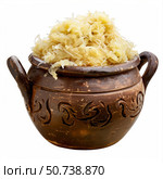 Sauerkraut overflowing from rustic clay pot on white background. Стоковое AI-изображение, AI-художник Иван Рябоконь / Фотобанк Лори