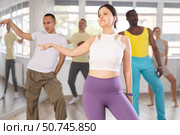 Asian girl with team of like-minded multinational people learn to elements of hip hop dance. Стоковое фото, фотограф Яков Филимонов / Фотобанк Лори