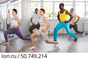 Young female fitness instructor leading upbeat Zumba class. Стоковое фото, фотограф Яков Филимонов / Фотобанк Лори