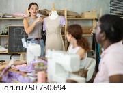 Sewing school girl teacher conducts lesson for students using mannequin. Стоковое фото, фотограф Яков Филимонов / Фотобанк Лори