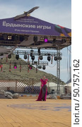 ELANTSY, IRKUTSK REGION, RUSSIA - July 5, 2025: Erdynskie Games– festival of nomadic peoples of Eurasia. Beautiful Buryat girl in red costume on open stage in Beauty Contest. Vertical video. Редакционное видео, видеограф Виктория Катьянова / Фотобанк Лори