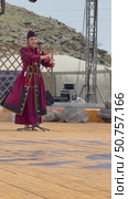 ELANTSY, IRKUTSK REGION, RUSSIA - July 5, 2025: Erdynskie Games– festival of nomadic peoples of Eurasia. Vertical video of beautiful Buryat girl in national red costume in Beauty Contest  on open stage. Редакционное видео, видеограф Виктория Катьянова / Фотобанк Лори