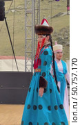 ELANTSY, IRKUTSK REGION, RUSSIA - July 5, 2025: Erdyn Games – festival of nomadic peoples of Eurasia. Vertical video of beautiful Buryat girl in beauty contest on open stage in national blue dress. Редакционное видео, видеограф Виктория Катьянова / Фотобанк Лори