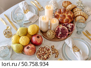 Elegant festive brunch table with fruit, bread, and candles display. Стоковое AI-изображение, AI-художник Мария Фадеева / Фотобанк Лори
