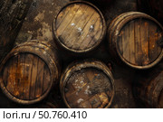 Weathered wooden barrels in rustic setting. Стоковое AI-изображение, AI-художник Иван Рябоконь / Фотобанк Лори