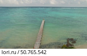 Person at the edge of a long wooden pier over calm sea waters in Yucatan Mexico. Стоковое видео, видеограф Igor Tichonow / Фотобанк Лори