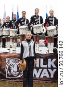 ANGARSK, IRKUTSK REGION, RUSSIA - July 13, 2025: XV International Silk Way Rally, racing competition. Group of beautiful female drummers prepare to perform on open stage before start of rally. Редакционное фото, фотограф Виктория Катьянова / Фотобанк Лори
