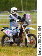 ANGARSK, IRKUTSK REGION, RUSSIA - July 13, 2025: XV International Silk Way Rally, motorcycle racing competition. Race on high-speed special stage in Angarsk. Participant woman №30 Zhdanova Ekaterina. Редакционное фото, фотограф Виктория Катьянова / Фотобанк Лори