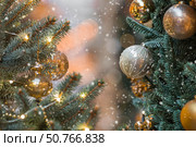 New Year's Eve card 2026. Christmas background. Holiday gold toys on the New Year's tree. Concept of preparing decorations and decor for the New Year. New Year's Eve card 2026. Стоковое фото, фотограф Photojuli / Фотобанк Лори