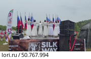 ANGARSK, IRKUTSK REGION, RUSSIA - July 13, 2025: XV International Silk Way Rally, racing competition. Video of girls in white dresses dancing on open stage before the start. Редакционное видео, видеограф Виктория Катьянова / Фотобанк Лори