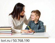 Мама помогает делать уроки своему сыну-школьнику. A mother helps her schoolboy son with his homework. Стоковое AI-изображение, AI-художник Смирнова Светлана / Фотобанк Лори