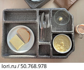 Hospital food on a hospital tray. Different dishes are arranged in the tray compartments. Photo from above. Стоковое фото, фотограф Vadzim Yakubovich / Фотобанк Лори