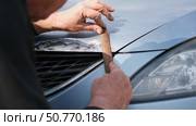 Car body shop. Repair man processes the welding seam using an angle grinder on replaced car part. Professional Body master grind old paint and rust. Rust damage. Rusting car. Hands with tool close-up. Стоковое видео, видеограф Марина Демидюк / Фотобанк Лори